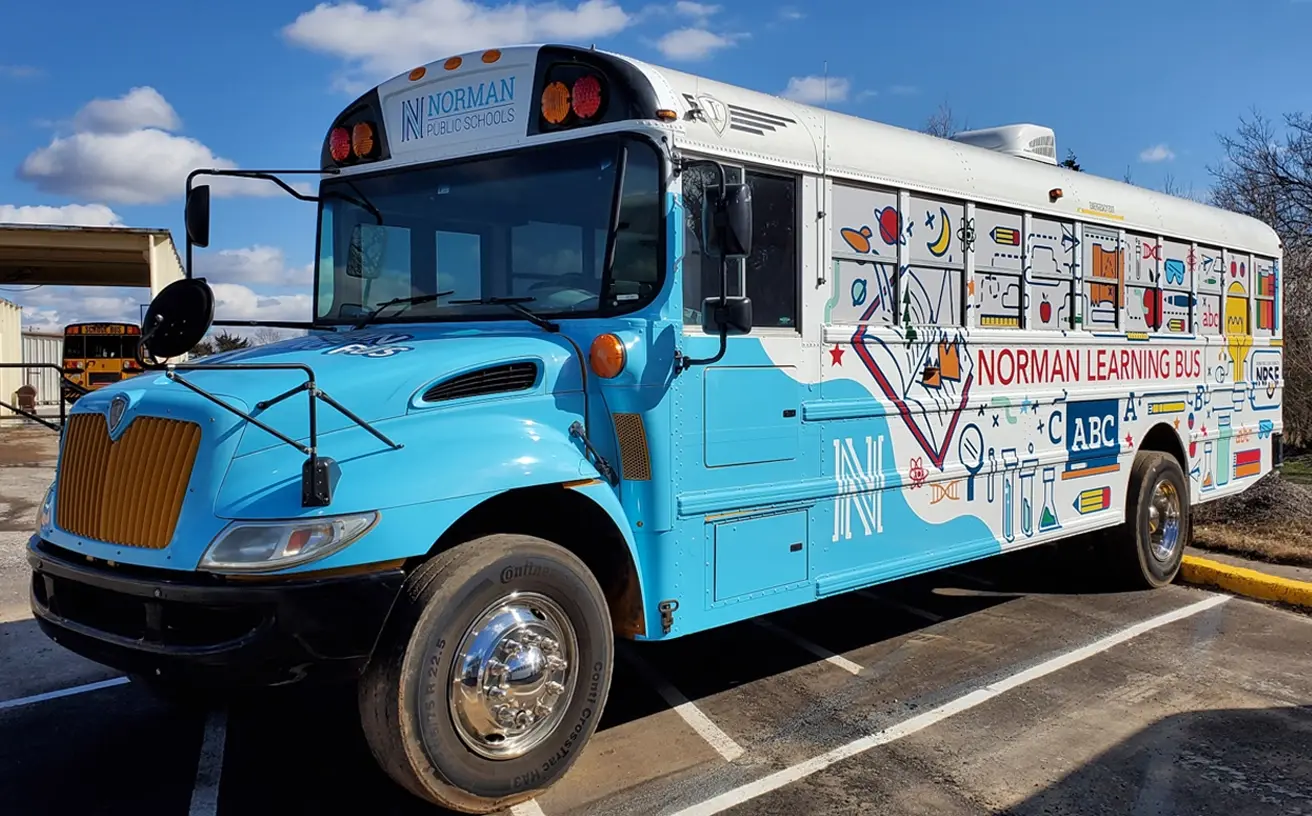 Detailed side view of the Learning Bus wrap's educational illustrations
