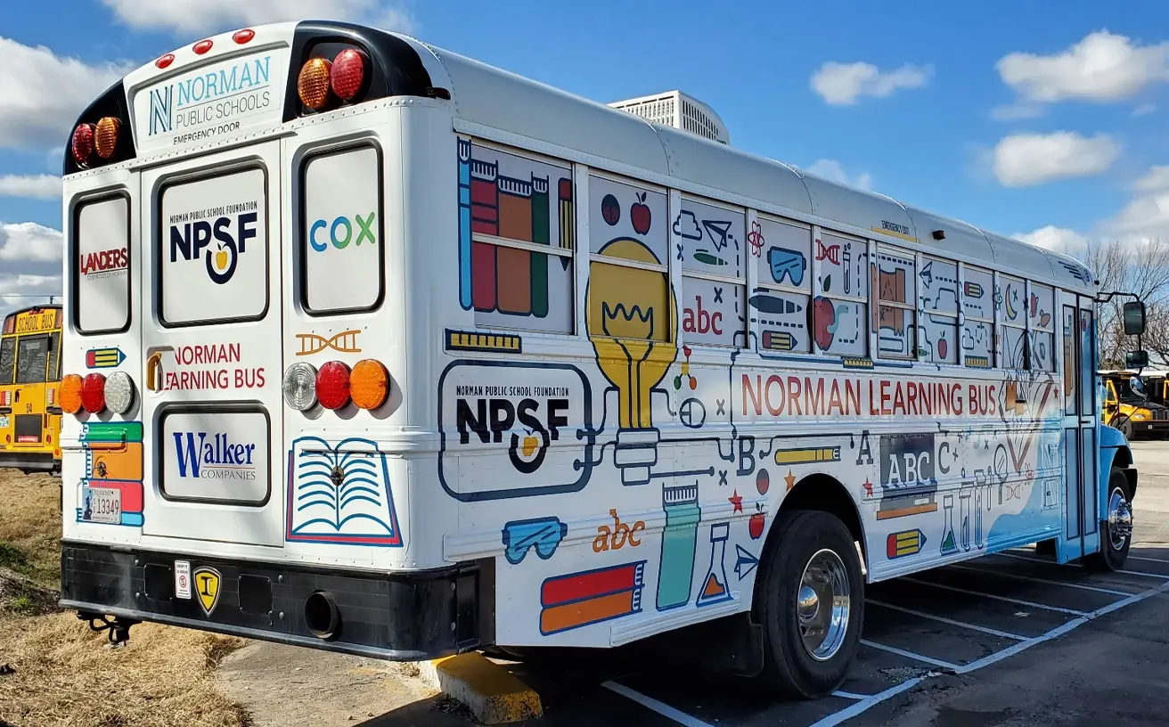 Detailed rear view of the Learning Bus wrap's educational illustrations